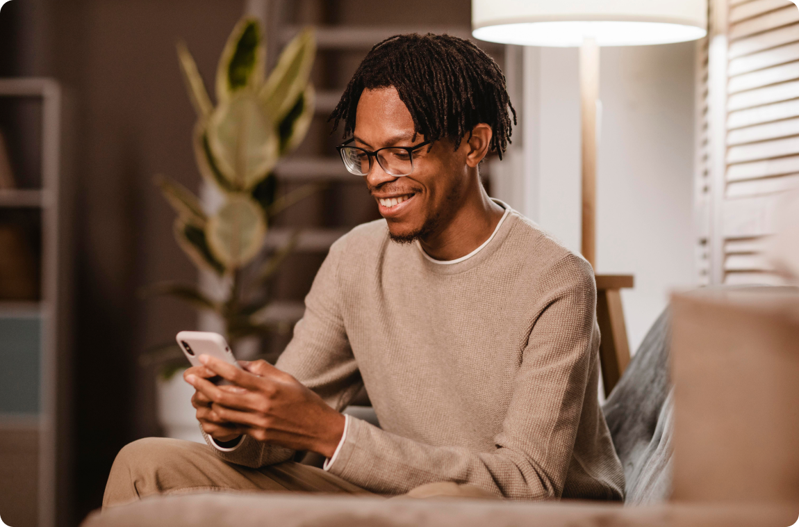 smiling-black-person-dressing-sweatshirt-using-phone